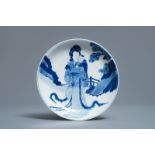 A Chinese blue and white semi-eggshell plate with a lady carrying a child, Kangxi