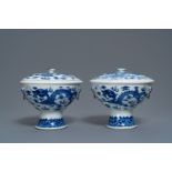 A pair of Chinese blue and white 'dragon' bowls and covers, 19th C.