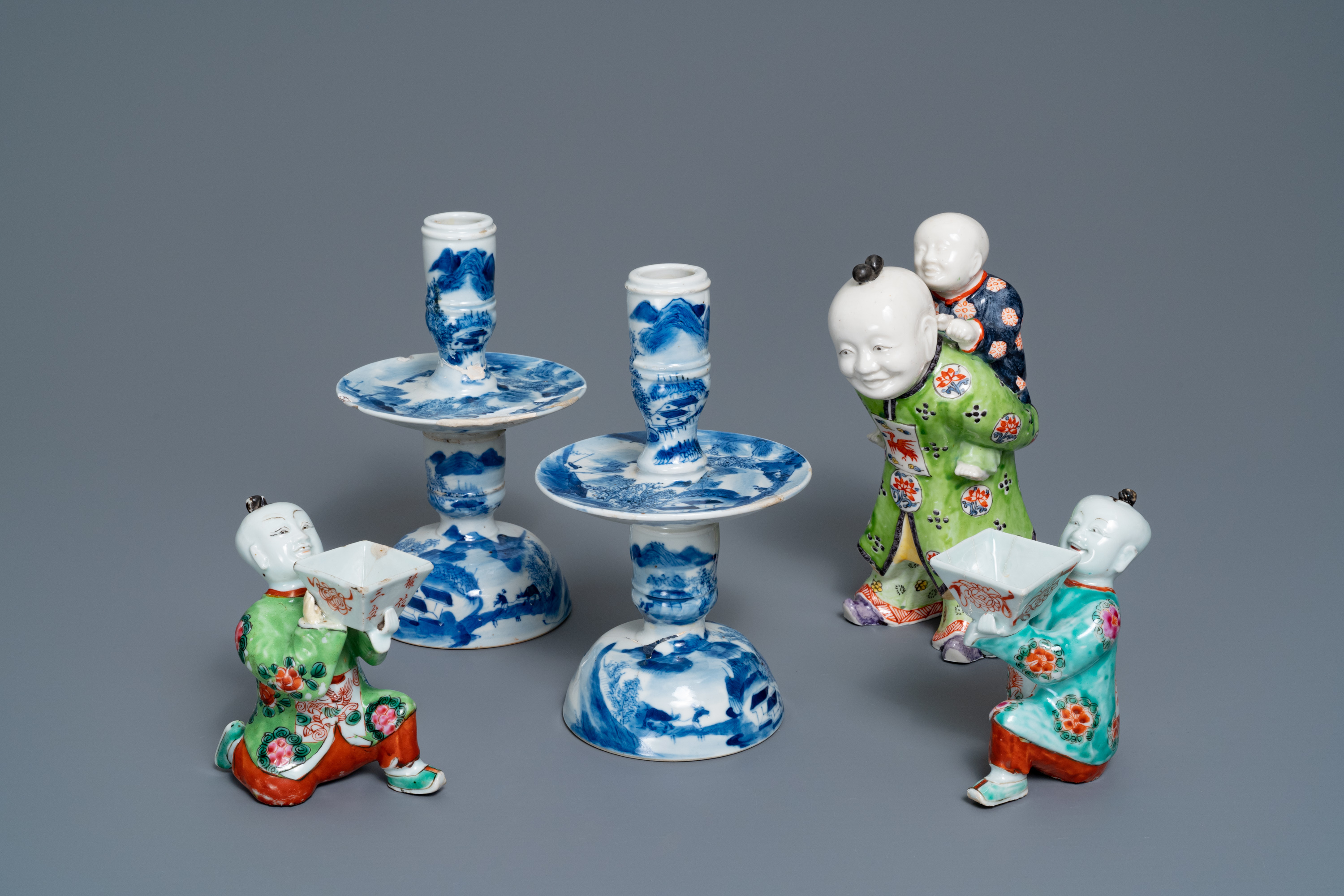 A pair of Chinese blue and white candlesticks and three famille rose figures of boys, 19th C. - Image 2 of 16