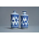 A pair of Chinese blue and white 'Buddhist emblems' rouleau vases, Kangxi