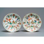 A pair of Chinese famille verte lotus-moulded 'Mu Guiying' plates, Kangxi