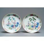 A pair of Chinese famille rose plates with ladies in a garden, Yongzheng/Qianlong