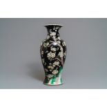 A Chinese famille noire 'magpie and prunus' vase, Kangxi