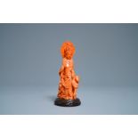 A Chinese carved red coral group of Guanyin with child, 19th C.
