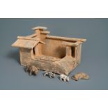 A Chinese earthenware model of a stable and five animals, Han