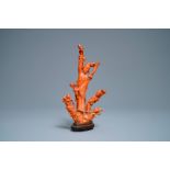 A Chinese carved red coral group of a lady and child, 19th C.