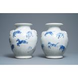 A pair of Chinese blue and white Nanking crackle-glazed vases with horses, 19th C.