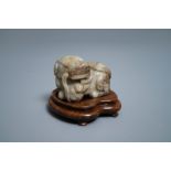 A Chinese pale grey-brown jade model of a Buddhist lion, 19/20th C.