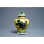 A Chinese yellow-ground famille verte vase and cover with Buddhist lions, 19th C.