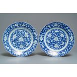 A pair of Chinese blue and white 'flower scroll' dishes, Kangxi