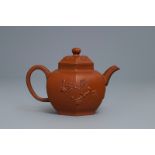 A Chinese Yixing stoneware teapot and cover with applied prunus design, Kangxi