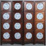 A Chinese wooden room divider with blue and white 'dragon' plaques, 19th C.