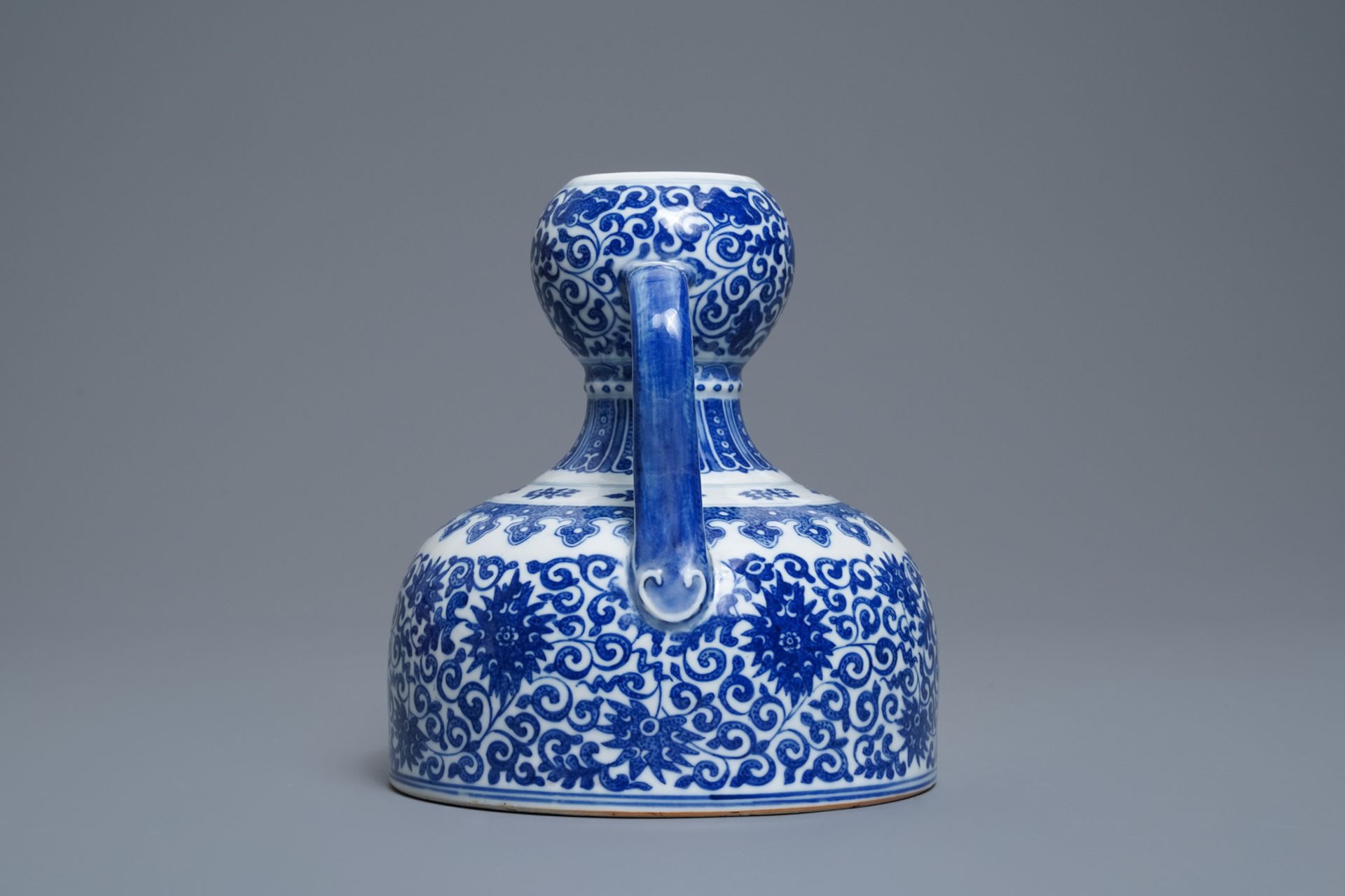 A Chinese blue and white two- Handled 'lotus scroll' jug, Qianlong mark, 19/20th C. - Image 2 of 6