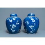 A pair of Chinese blue and white 'prunus on cracked ice' jars and covers, 19th C.