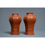 A pair of Chinese Yixing stoneware baluster vases with applied design, Kangxi