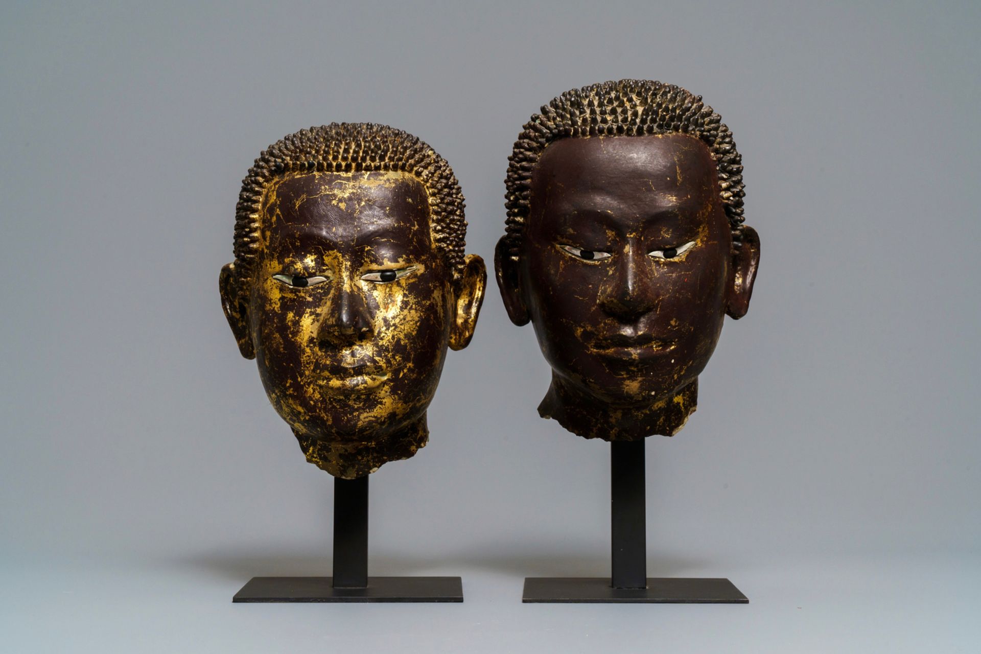 Two gilt-lacquered terracotta and stucco heads of Buddha, Thailand, Ayutthaya period, 18th C.