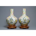 (NO ONLINE BIDDING) A pair of Chinese famille rose millefleurs bottle vases, Qianlong mark, 19/20th
