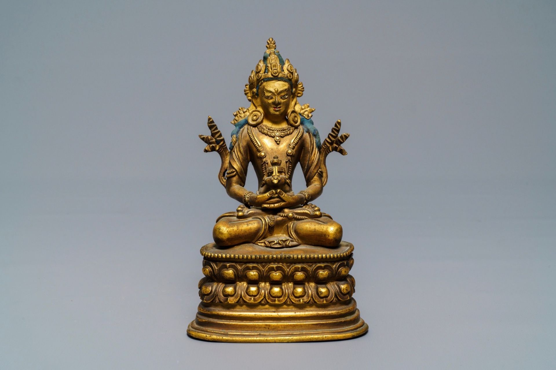 A Chinese gilt bronze figure of Amitayus, 17/18th C.