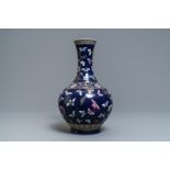 A Chinese blue-ground bottle vase with overglaze butterfly design, Guangxu mark, 19/20th C.