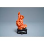 A Chinese carved red coral group of a boy with a parrot, 19/20th C.