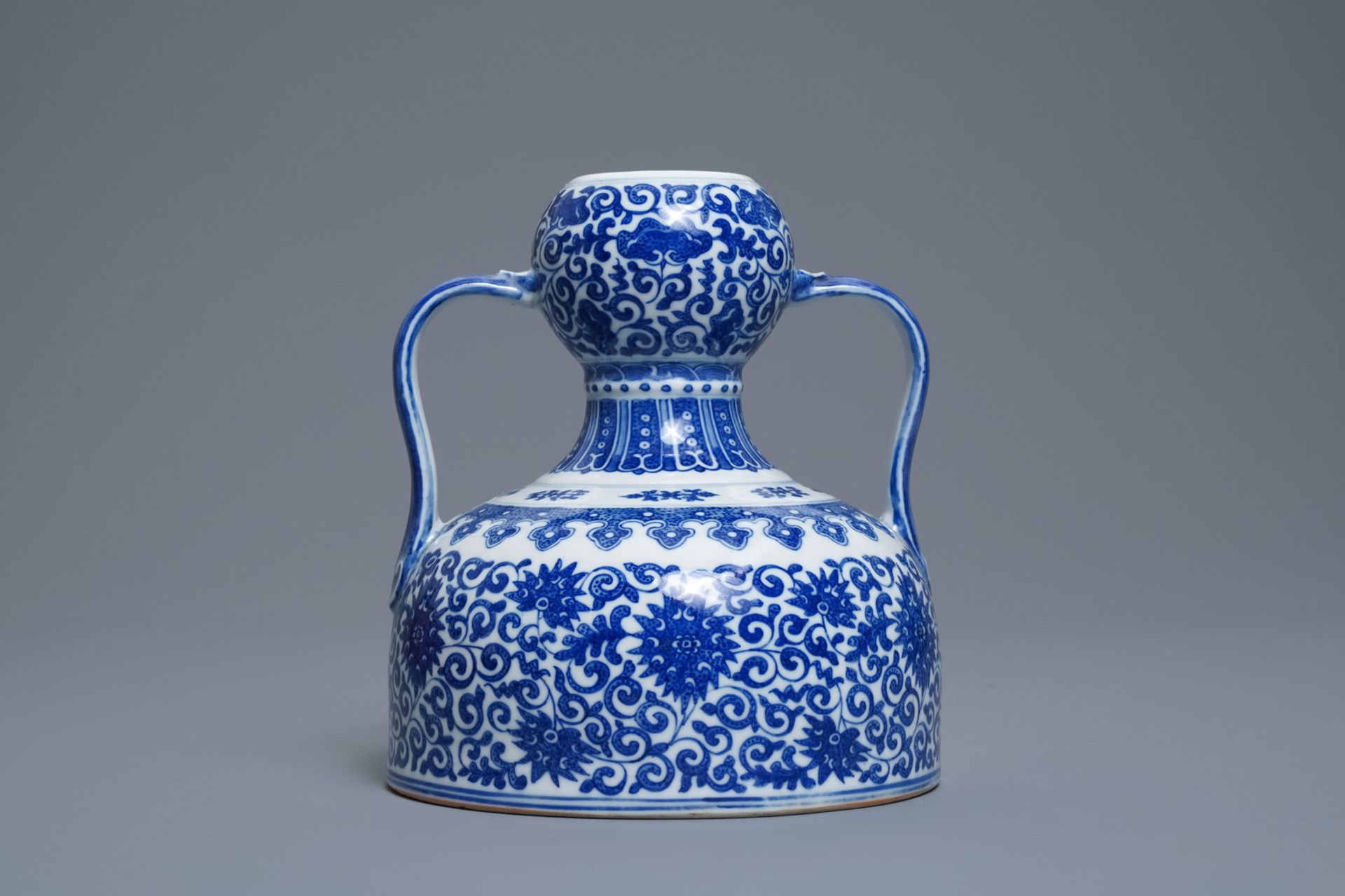 A Chinese blue and white two- Handled 'lotus scroll' jug, Qianlong mark, 19/20th C. - Image 3 of 6