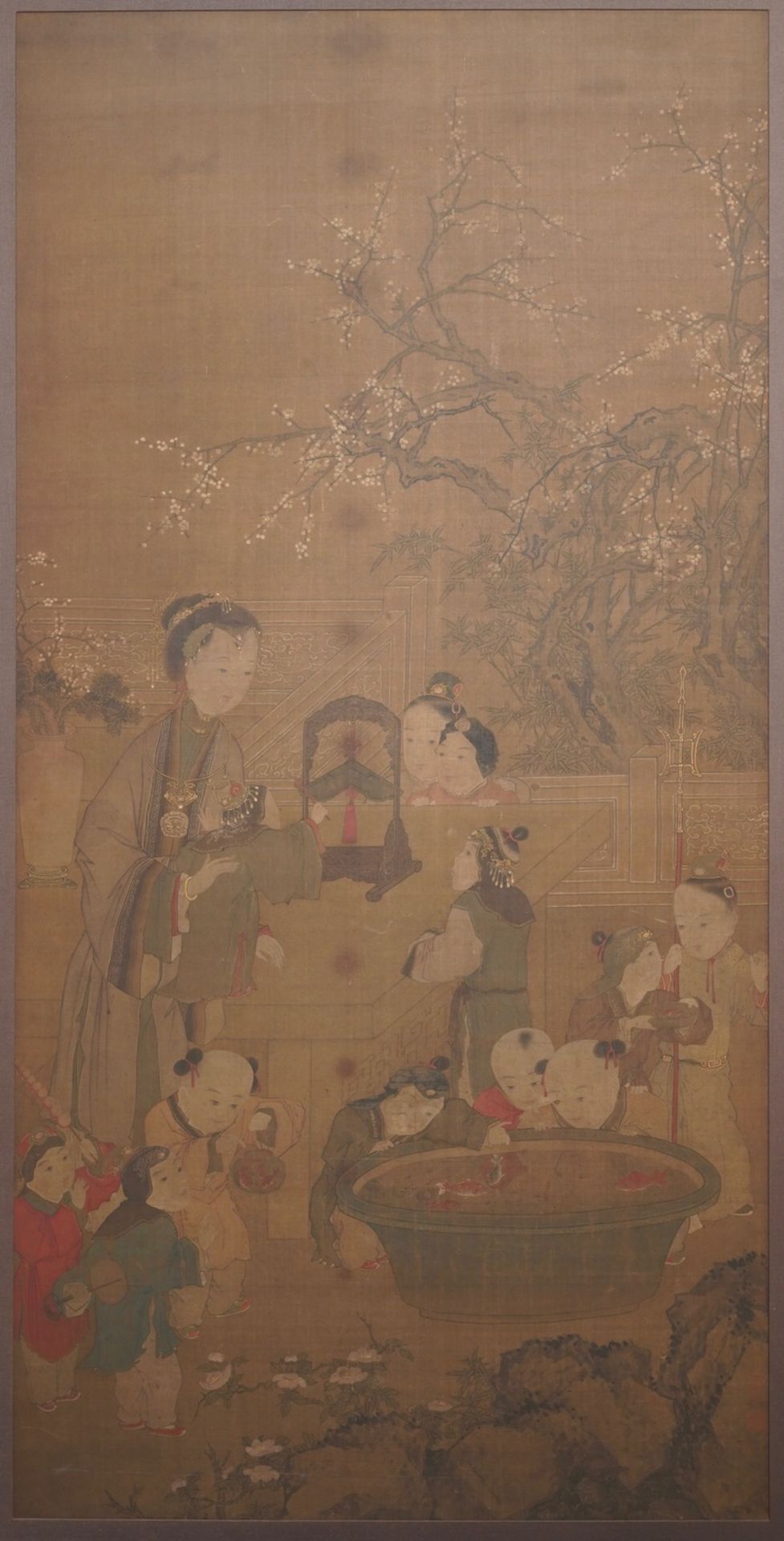 Chinese, after Su Hanchen (1094-1172), ink and colour on silk: a lady and children near a fish bowl