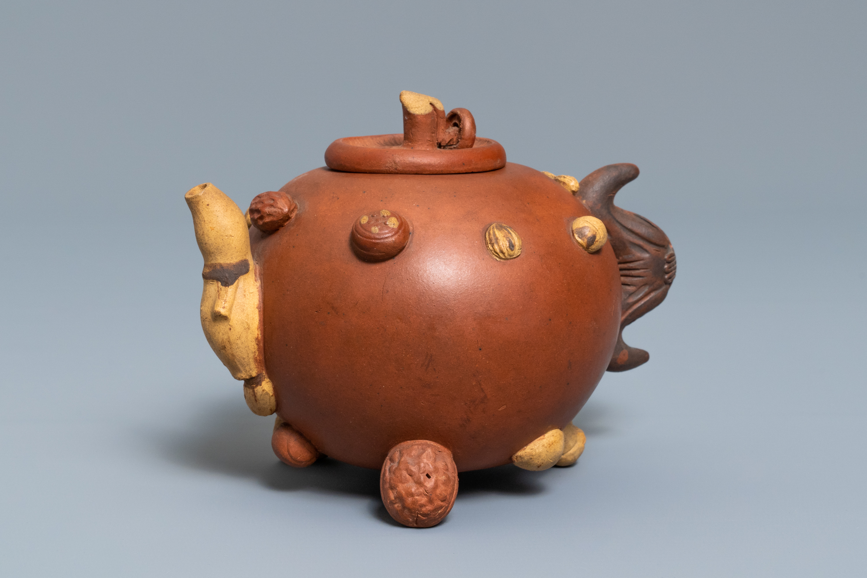 A Chinese Yixing stoneware relief-decorated teapot with nuts and fruits, impressed mark, 19th C. - Image 2 of 8