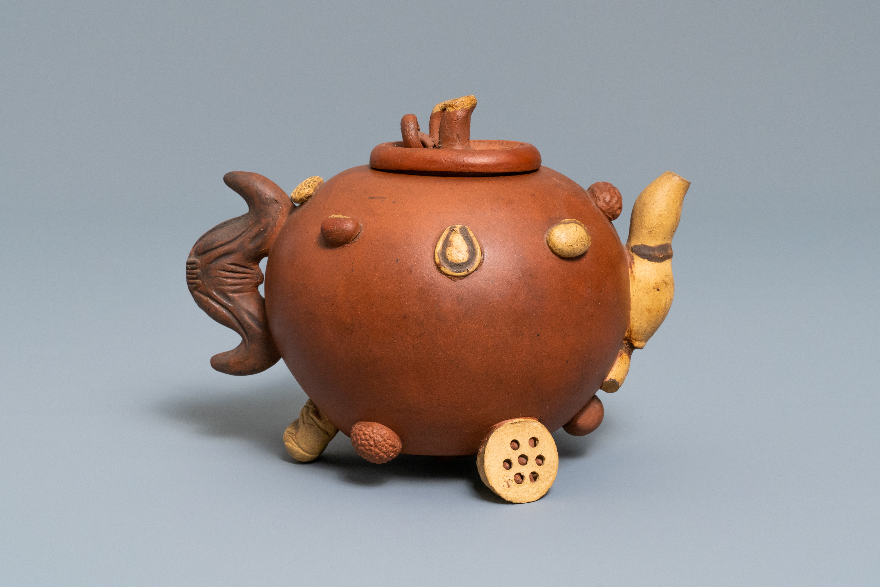 A Chinese Yixing stoneware relief-decorated teapot with nuts and fruits, impressed mark, 19th C. - Image 5 of 8