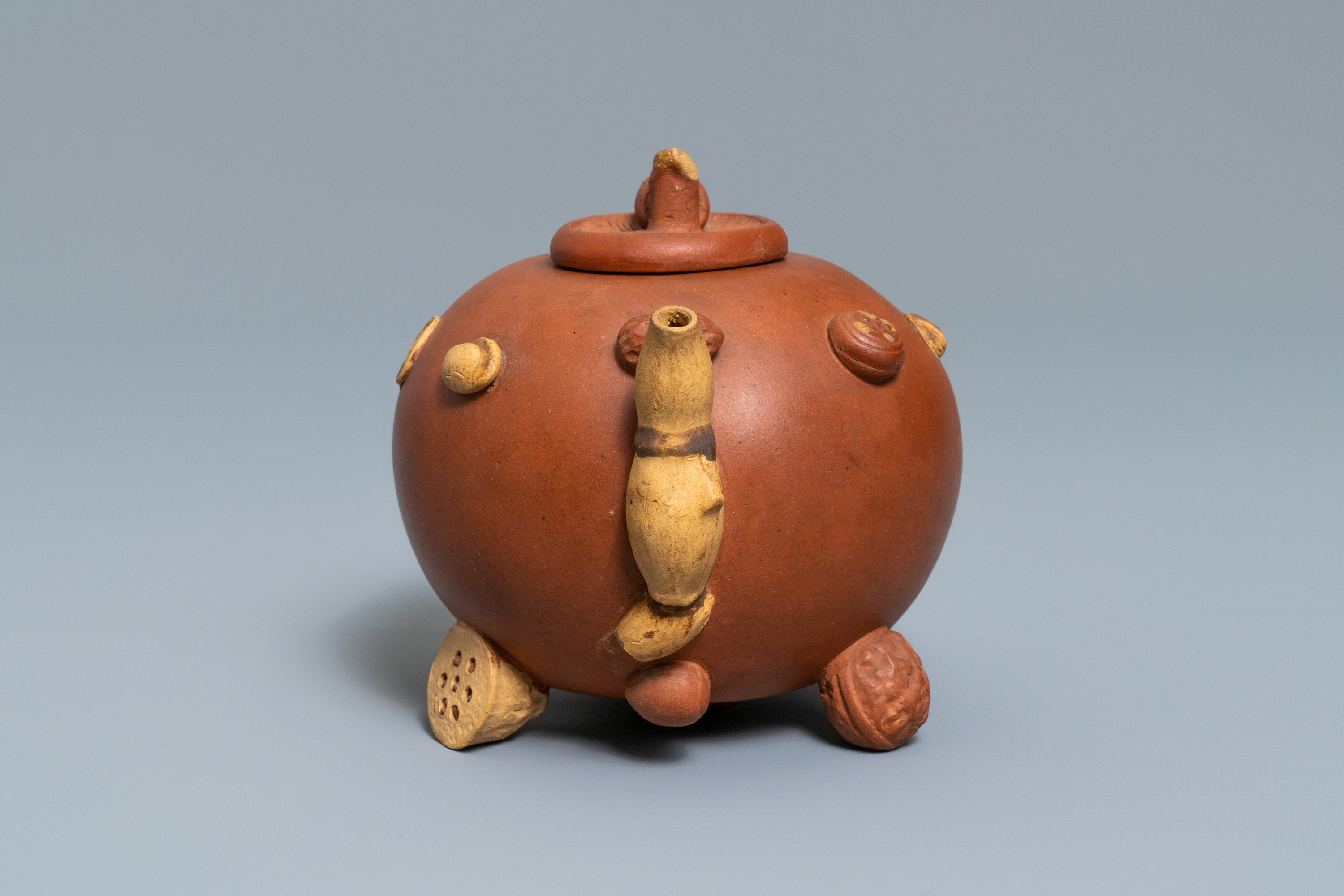 A Chinese Yixing stoneware relief-decorated teapot with nuts and fruits, impressed mark, 19th C. - Image 6 of 8