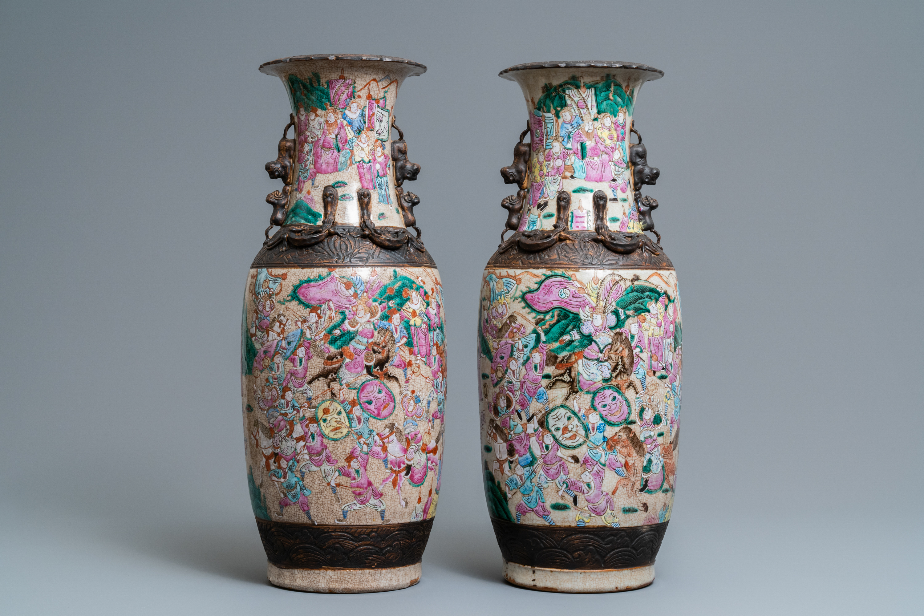 A pair of Chinese Nanking famille rose crackle-glazed 'warrior' vases, 19th C.