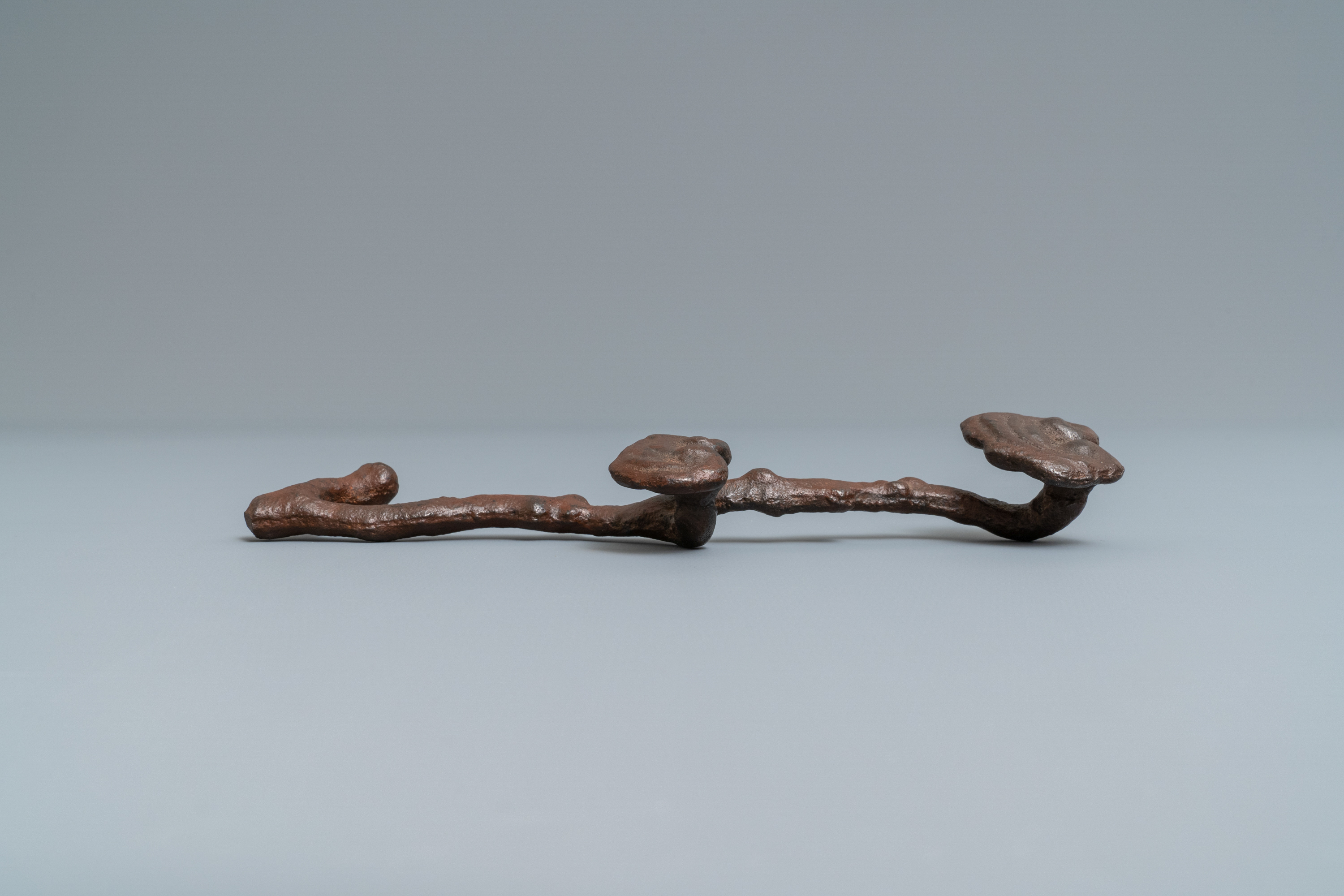 A Chinese cast iron brush rest in the shape of a lingzhi ruyi scepter, Ming - Image 3 of 7