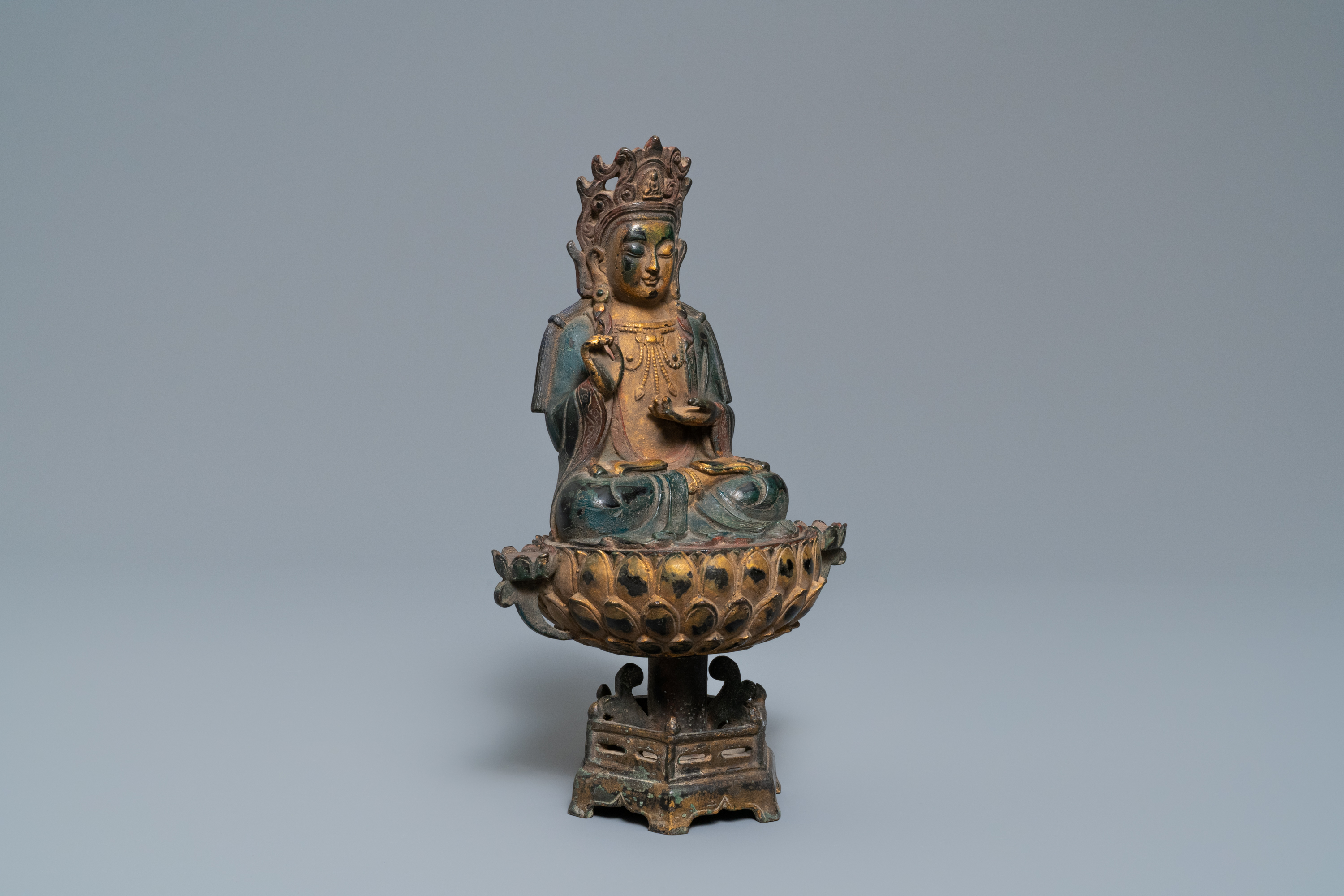 A Chinese polychrome and gilt bronze figure of Buddha on a lotus throne, Qing