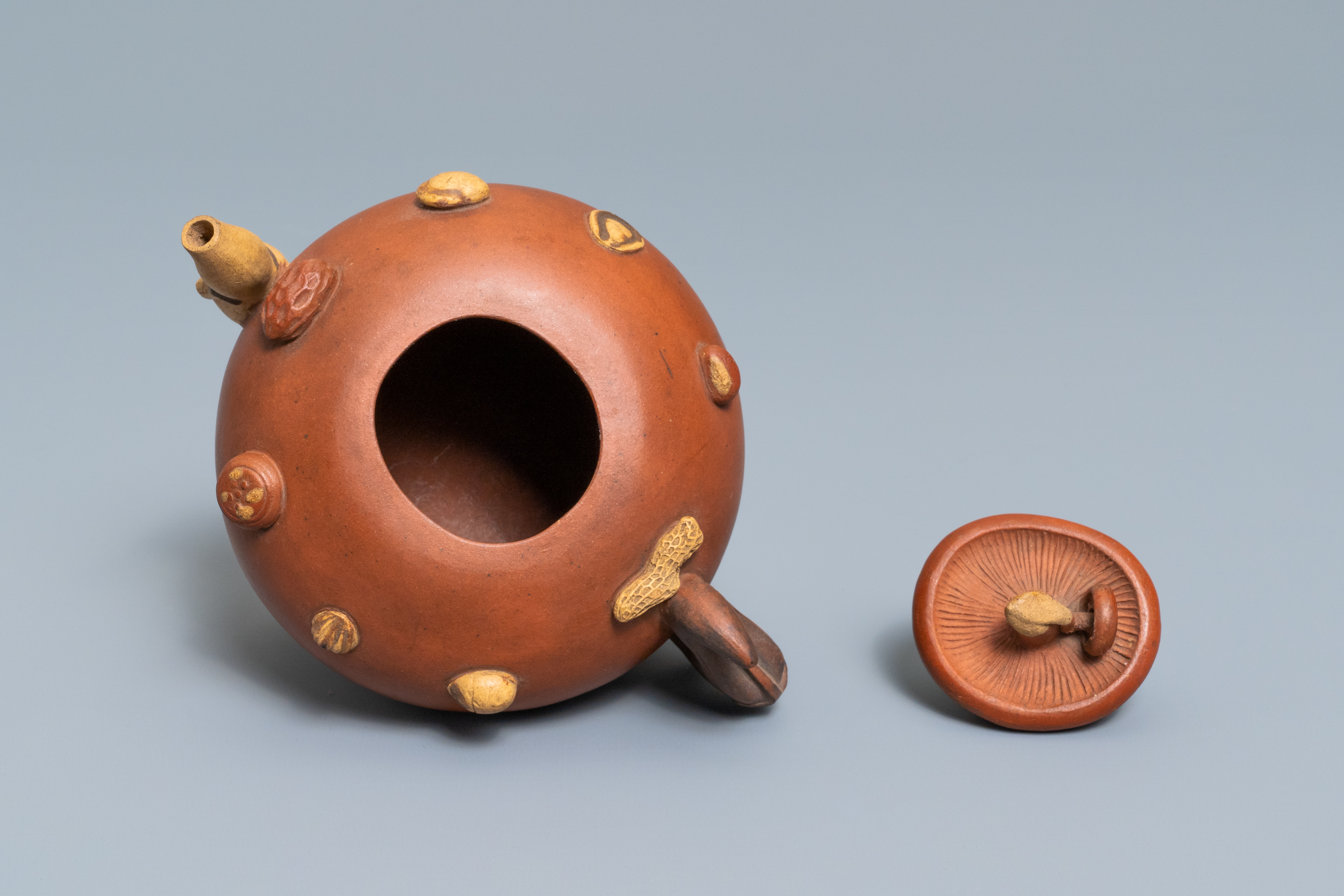 A Chinese Yixing stoneware relief-decorated teapot with nuts and fruits, impressed mark, 19th C. - Image 7 of 8