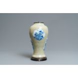 A Chinese blue and white on carved celadon-glazed ground vase, Kangxi