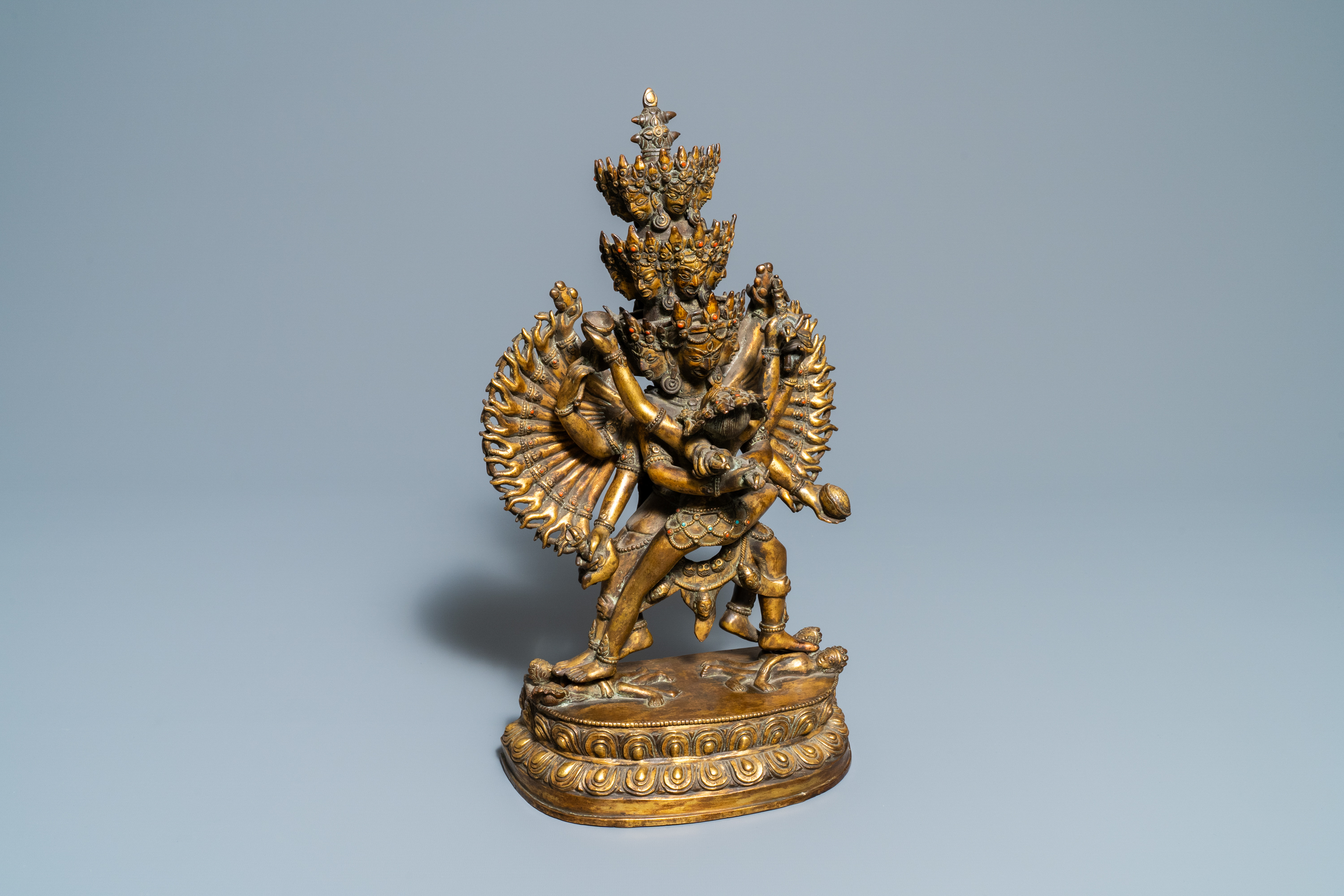 A large Sino-Tibetan coral-inlaid gilt bronze figure of Kapaladhara Hevajra, 18/19th C.