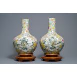 A pair of Chinese famille rose millefleurs bottle vases, Qianlong mark, ca. 1900