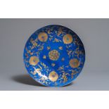 A Chinese powder blue and gilt dish with floral design, Kangxi