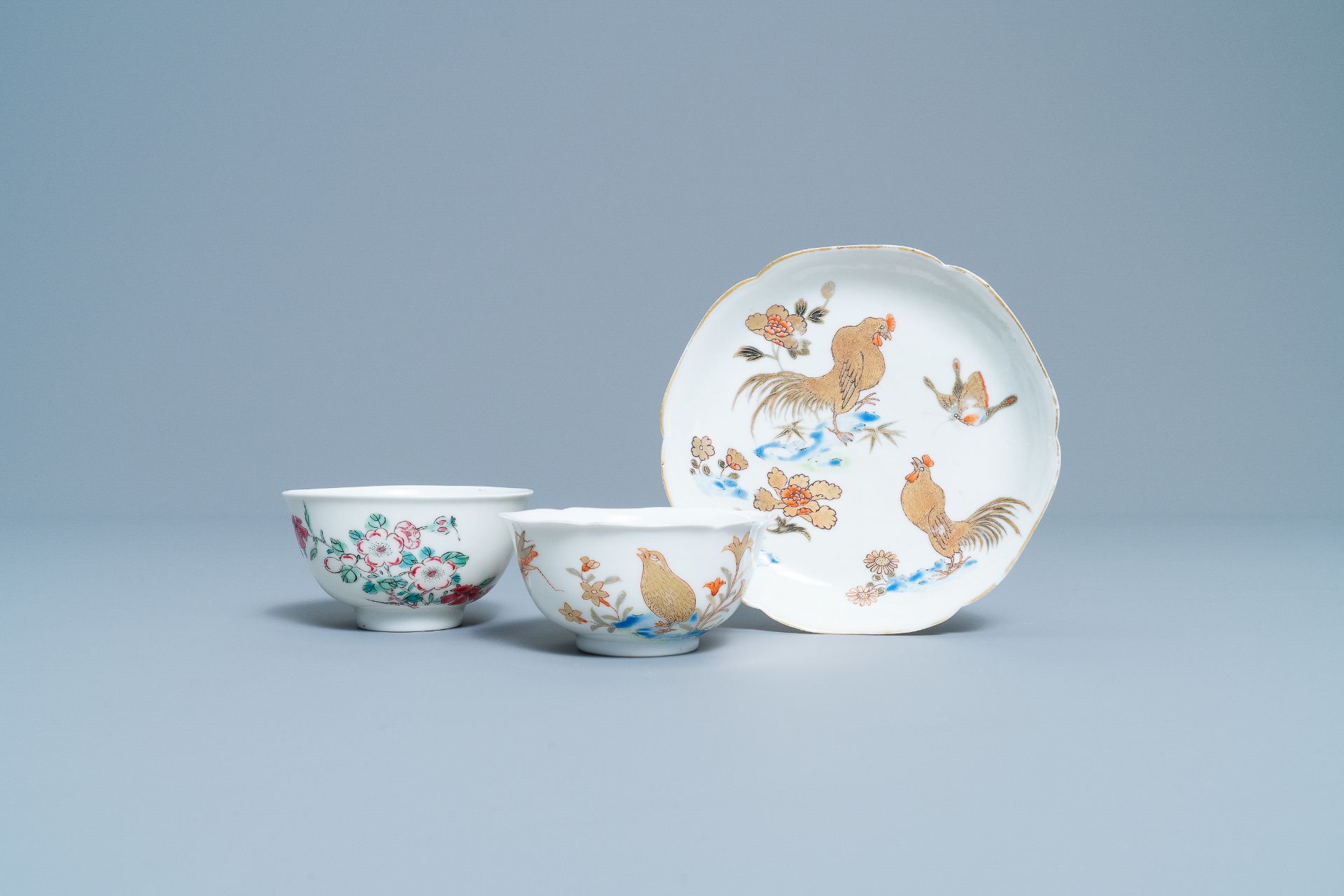 A Chinese gilt-decorated cup and saucer and a floral famille rose cup, Yongzheng