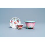 A Chinese famille rose cup and saucer and a 'magnolia' cup, Yongzheng