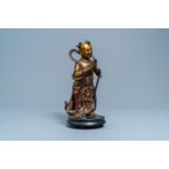 A Chinese lacquered and gilt bronze figure of a servant, Ming