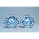 A pair of Dutch Delft blue and white plaques with mascaron suspensions, 18th C.