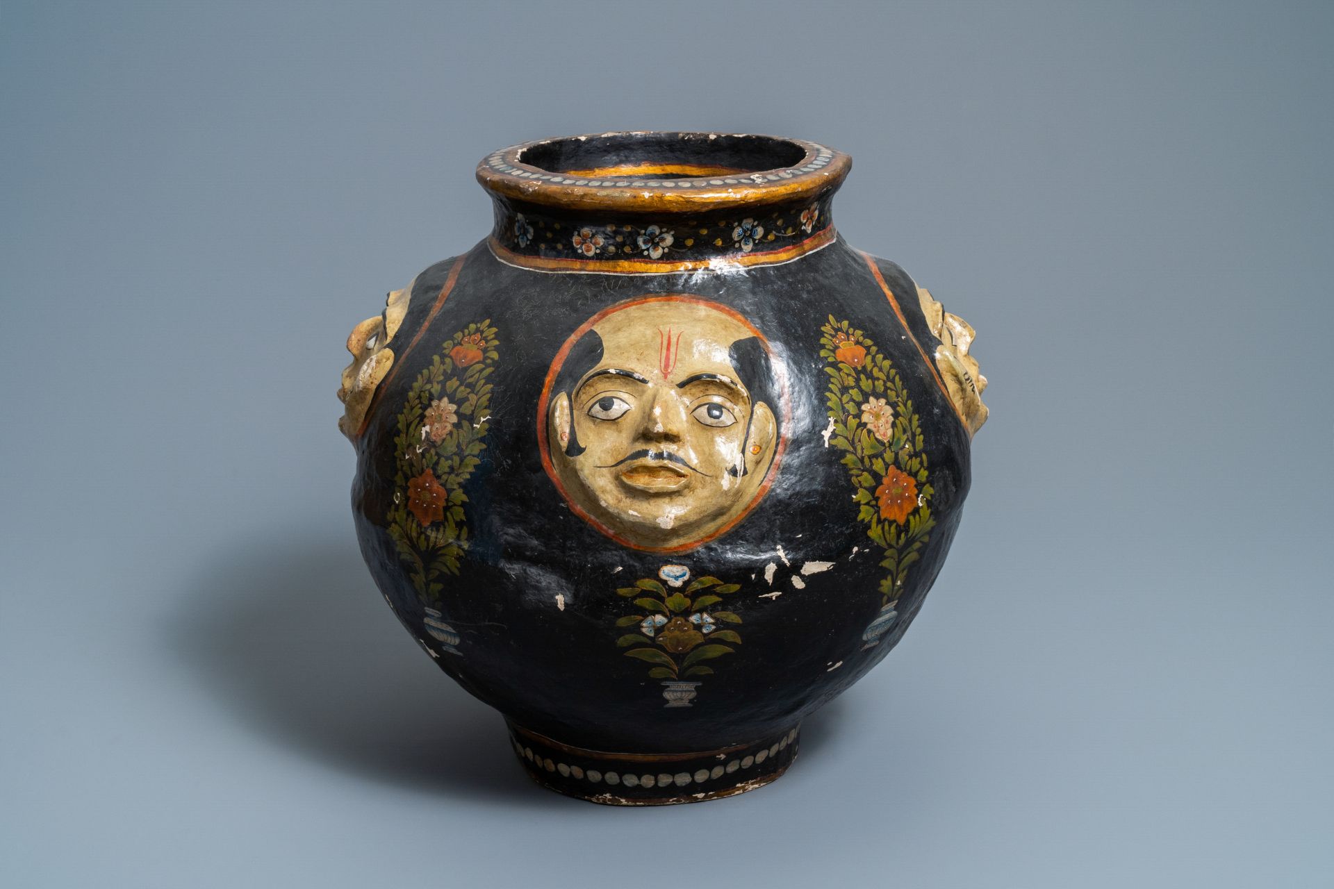 A relief-decorated papier-mache vase with four faces, Kashmir, India, 19th C.