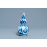 A Chinese blue and white double gourd vase with figures in a landscape, Transitional period