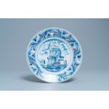 A Dutch Delftware blue and white dish with a large battle ship, Bolsward, Friesland, 18th C.