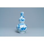 A Chinese blue and white double gourd vase with figures in a landscape, Transitional period