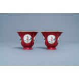 A pair of Chinese famille rose ruby-ground wine cups with foreigners, Qianlong