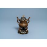 A Chinese bronze tripod censer with 'lotus leaf' cover and stand, 17/18th C.