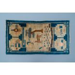 A rectangular Chinese hand-knotted wool carpet with a crane and a deer, 19/20th C.