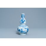 A Chinese blue and white double gourd vase with figures in a landscape, Transitional period