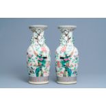 A pair of Chinese famille rose vases with birds among blossoming branches, 19th C.